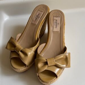Valentino Garavani Patent Leather Bow Wedge Mules in Mustard Tan